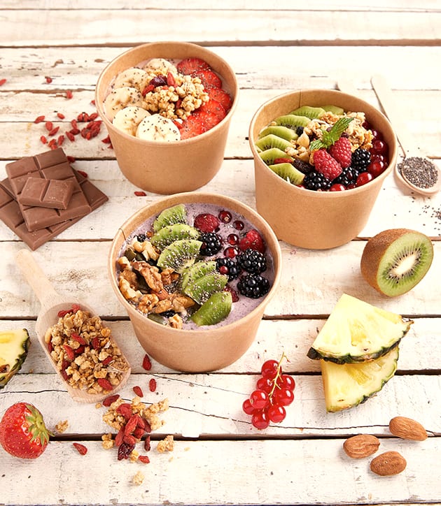 Smoothie bowls with fruit, granola and nuts