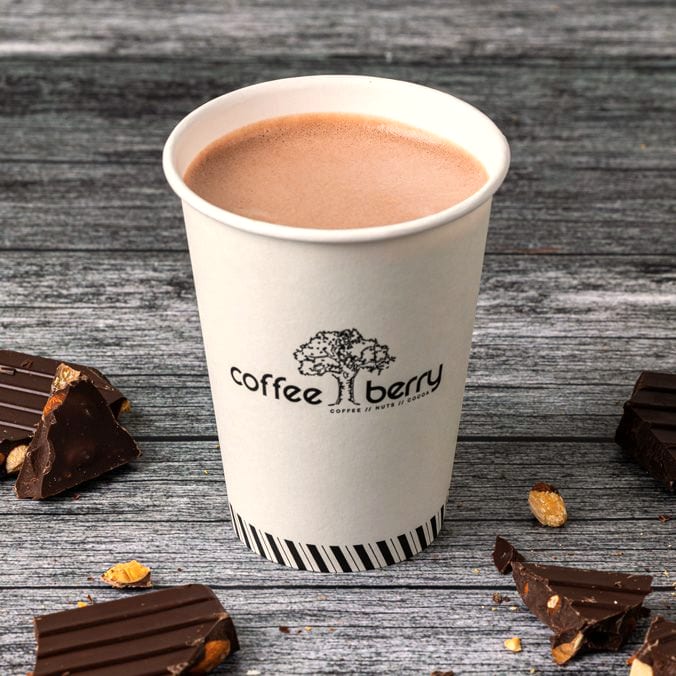 A Coffee Berry hot chocolate in a cup with pieces of chocolate